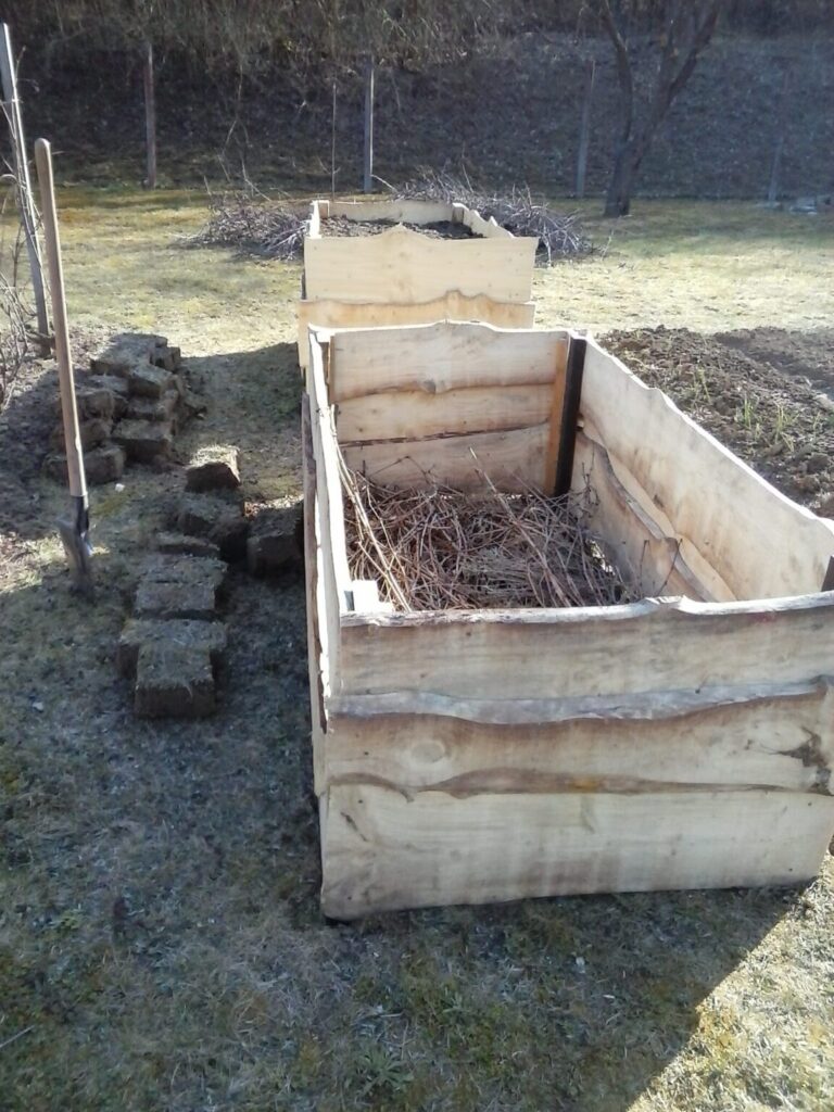 Magaságyás építése közben az első réteg kialakítása, alul száraz gallyakkal és venyigével feltöltve